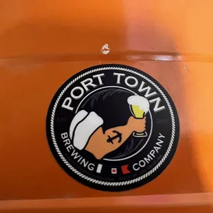 a hand holding a glass of beer