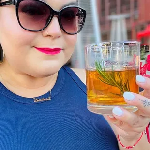 a woman holding a glass of tea