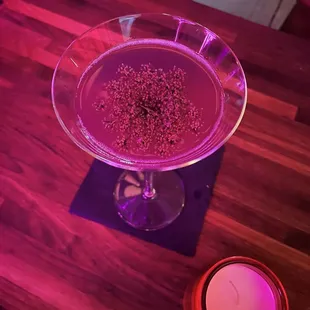 a purple cocktail with sprinkles