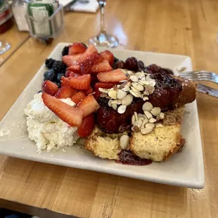 Oatmeal Cobbler French Toast - French toast topped with an oatmeal-crumb crust, fruit compote, lemon crème anglaise, and powdered sugar