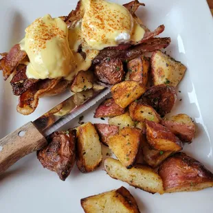 Pepper Bacon Benedict (poached eggs, pepper bacon, hollandaise, paprika, homemade english muffin) with herb roasted potatoes (or salad)