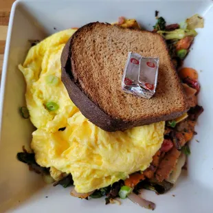 Farmer&apos;s Hash Bowl (3 eggs any style, vegetables, roasted onions, potatoes, herbs) with wheat toast and bacon/sausage/mushrooms (extra $)