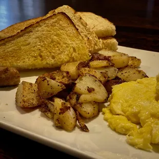 Scrambled eggs, sausage, potatoes and sourdough toast