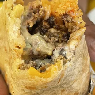 a person holding a burrito