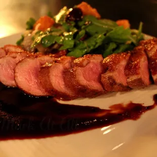 Duck Breast with cherry molasses and arugula salad with cherries and corn bread croutons.