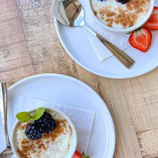 Rice Pudding topped with cinnamon, berries, and mint