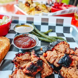 a bbq platter with meat and side dishes