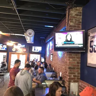 a large group of people sitting at a bar
