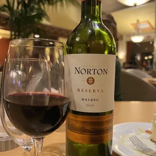 a bottle of wine and a glass of wine