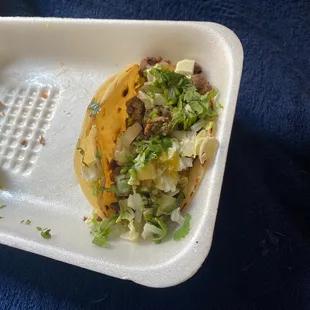 a taco in a styrofoam container