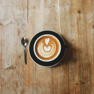 a cappuccino on a wooden table