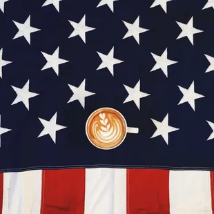 a cup of cappuccino in front of an american flag