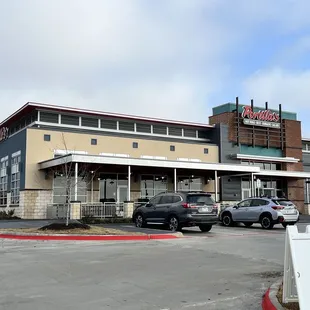 a parking lot with cars parked in front of it