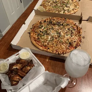 Naked wings with blue cheese and Parmesan garlic sauce on side, Philly Cheesesteak Pizza and Supreme Pizza