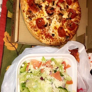 Small pepperoni and mushroom pizza and a side salad.