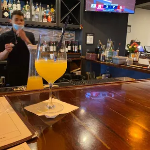 a glass of orange juice on the bar