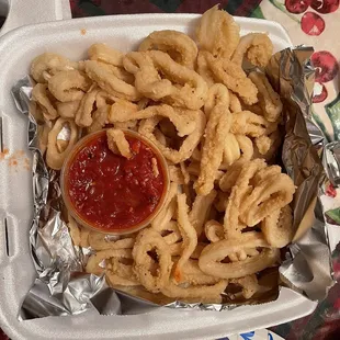 Fried calamari with sauce perfectly breaded and cooked remains me back home