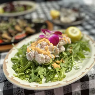a plate of food on a checkered tablecloth