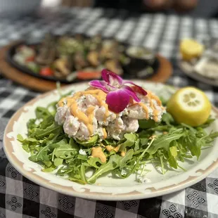 a plate of food on a checkered tablecloth