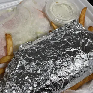 a sandwich wrapped in aluminum foil