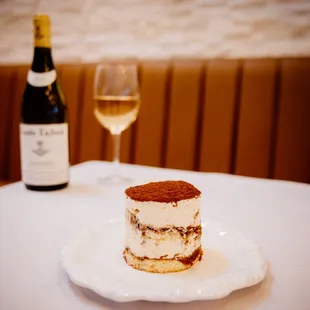 Tiramisu 
Delicate coffee-soaked ladyfinger cookies, stacked between rich mascarpone cream, with a hint of cocoa powder dusted on top.