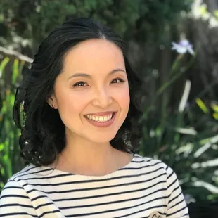 a smiling woman in a striped shirt