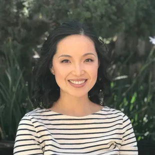 a smiling woman in a striped shirt