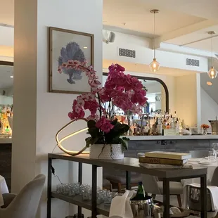 a dining room with a bar and chairs
