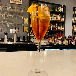 a drink in a glass on a bar counter