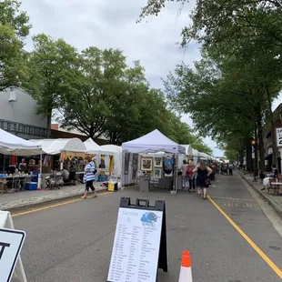 a street scene with tents and people