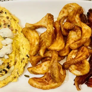 Portum Omelet (3 eggs, Parmesan Cheese, Lump Crabmeat, tomatoes, peppers, mushrooms &amp; onions), home potatoes &amp; Thick-Sliced Applewood Bacon.