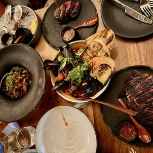 Ribeye steak, mussels, squid ink pasta, raw oysters