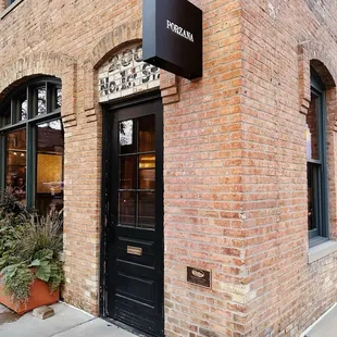 a brick building with a black door