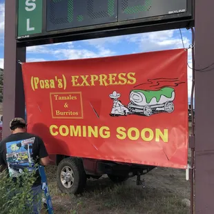 a man standing next to a sign