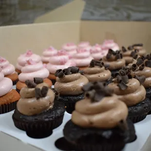 a variety of cupcakes in a box