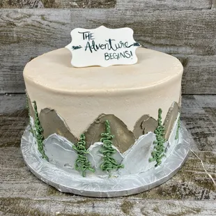 a frosted cake with a sign on top