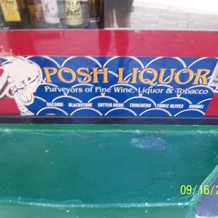 Signage for Posh Liquor is located in the window and not on exterior of building.