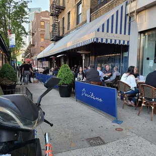 a scooter parked on the sidewalk