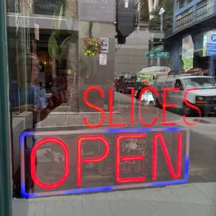 a slice open sign in the window