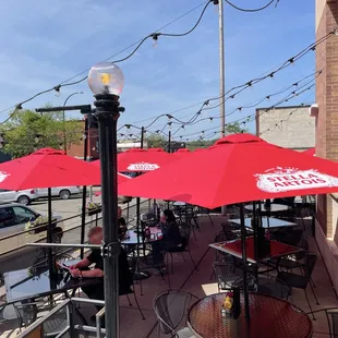tables with red umbrellas