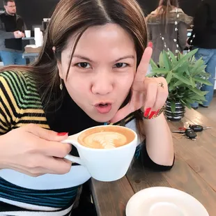a woman holding a cup of coffee