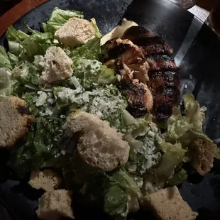 a plate of food with meat, salad, and bread