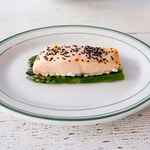 Steamed salmon with traditional Filipino marinade on market vegetables