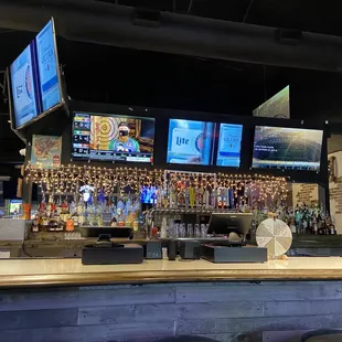 a bar with multiple televisions