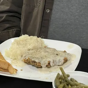 Chicken fried steak  with mashed potatoes and green beans and Texas toast