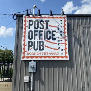 a post office sign on the side of a building