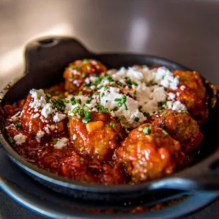 a bowl of meatballs in a tomato sauce