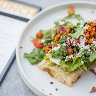 a plate of food with a menu in the background