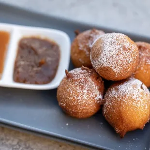 a plate of doughnuts and dipping sauce