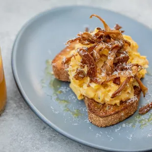 a plate of food and a glass of orange juice